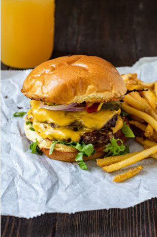 Smash burgers cooking on grill